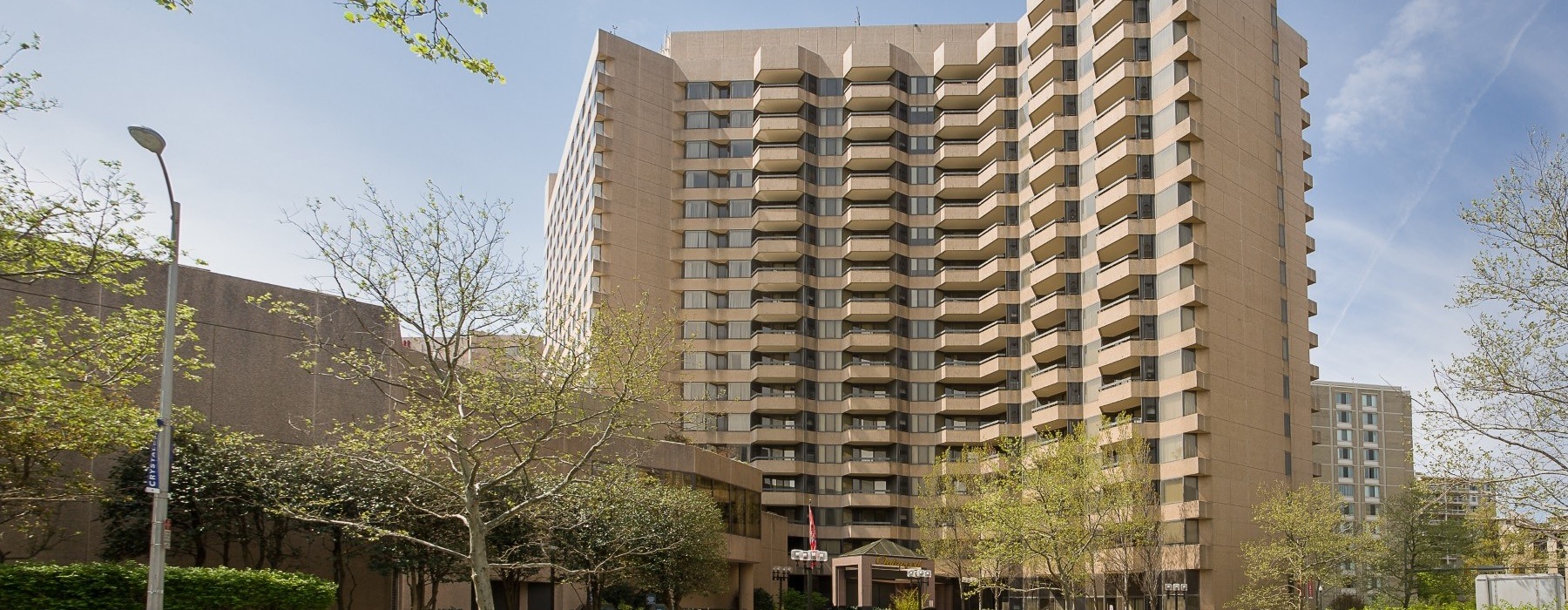 a tall building with trees in front of it