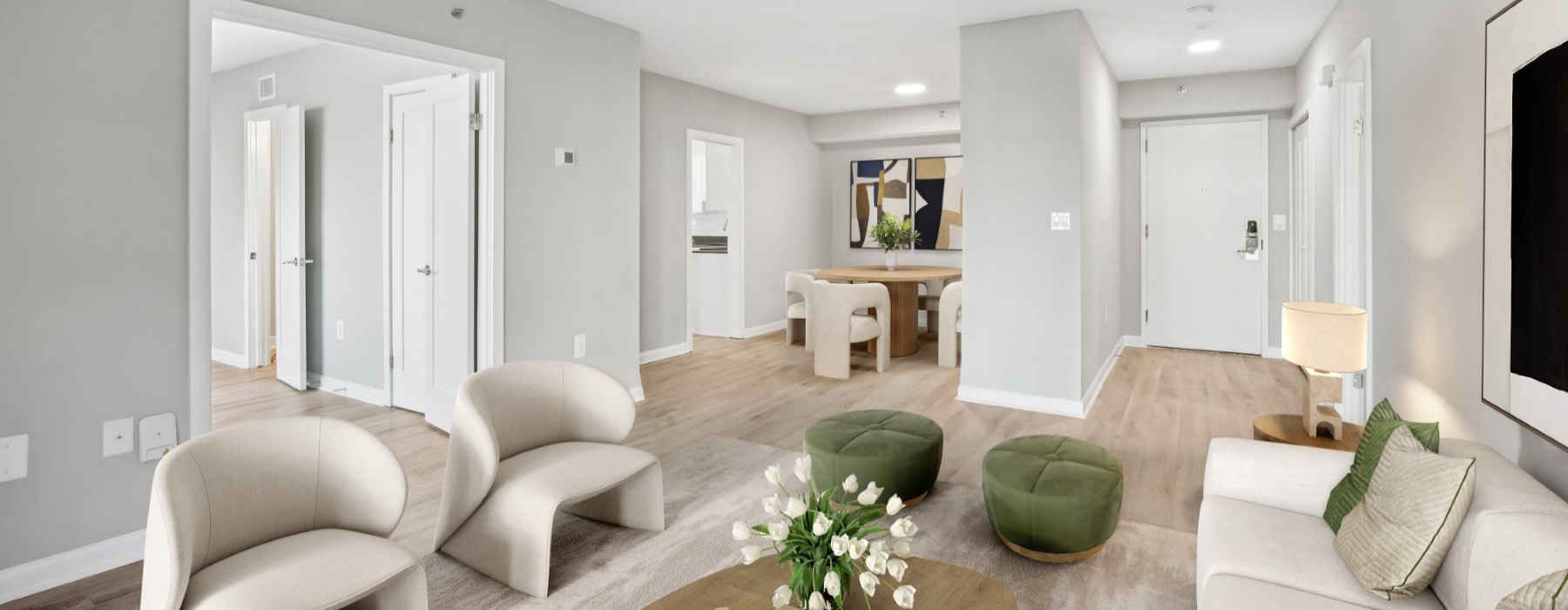 a living room with a large white couch and a round coffee table