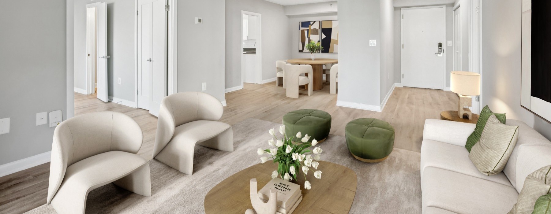 a living room with a large white couch and a round coffee table