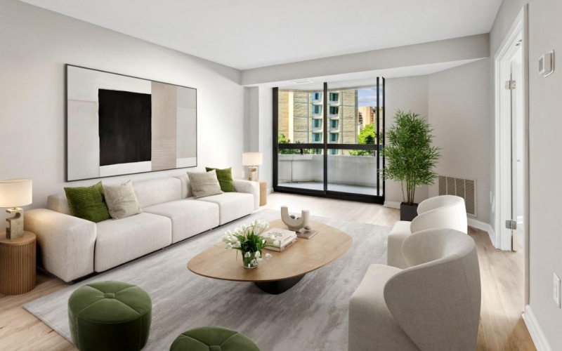 a living room with a couch, chairs and a coffee table