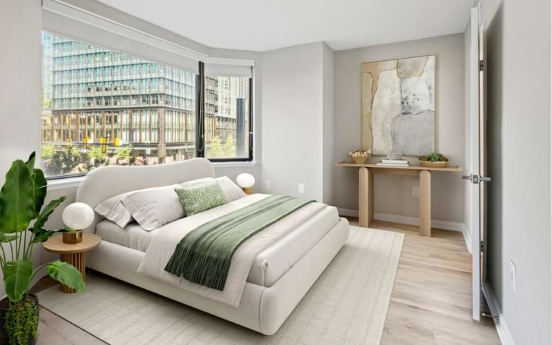 a bedroom with a bed and a plant