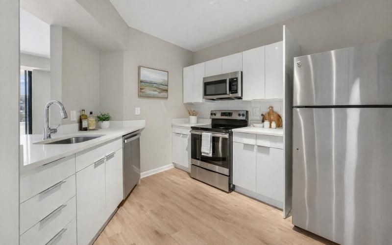a kitchen with white cabinets